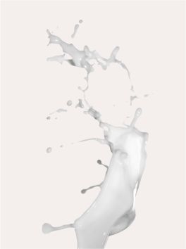 Splash of white liquid with droplets against a light background, illustrating fluid motion and texture.