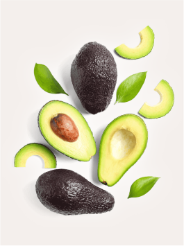 Golden-green avocado oil in a clear glass bottle, pressed from ripe avocado fruit, showing its rich natural color